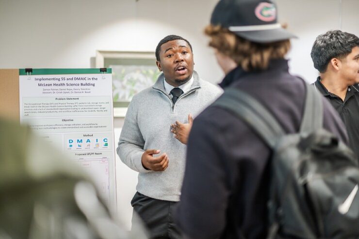 A student presents his poster at the 15th CRC Symposium