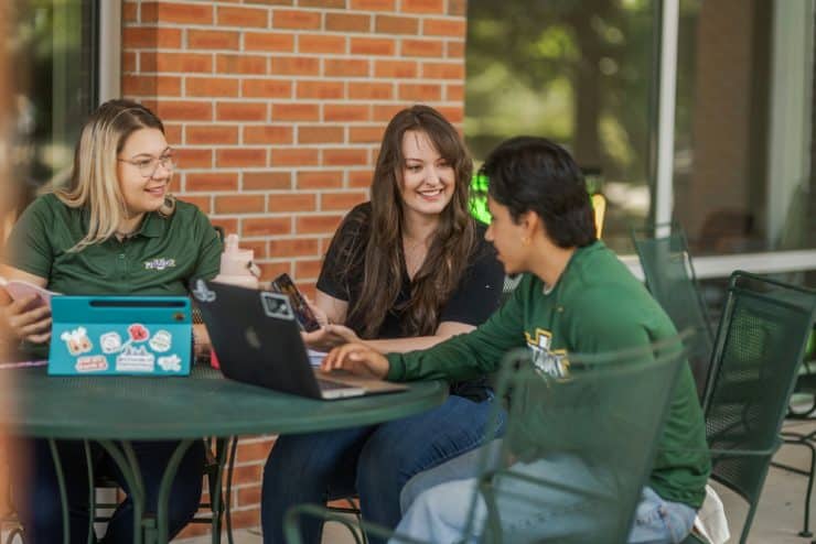 Students work on their computers outside Matthews Ministry Center
