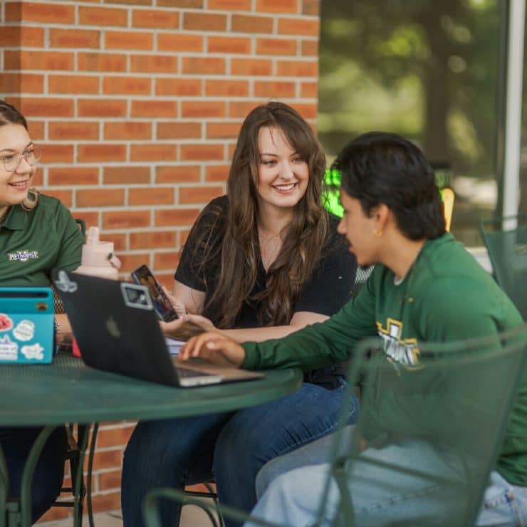 Students work on their computers outside Matthews Ministry Center