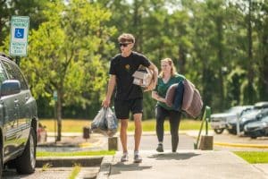 A student and parent arrive for move-in day.