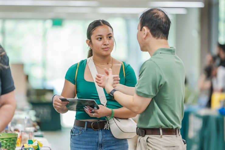 A prospective student talks with Dr. Jie Zhou