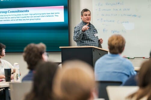 A professor speaks to students in a School of Medicine classroom