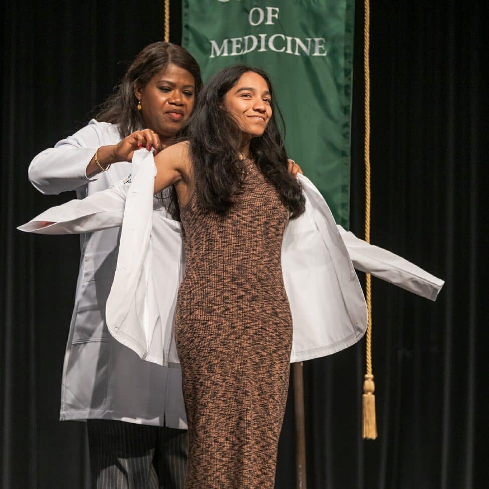 A medical student receives her white coat