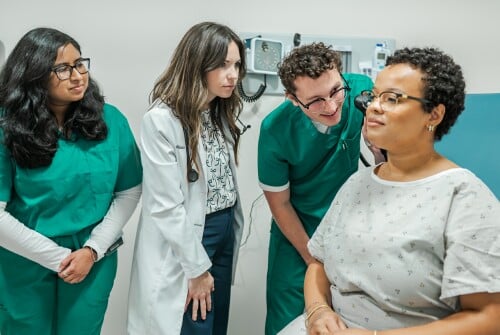 Medical School students work with a standardized patient